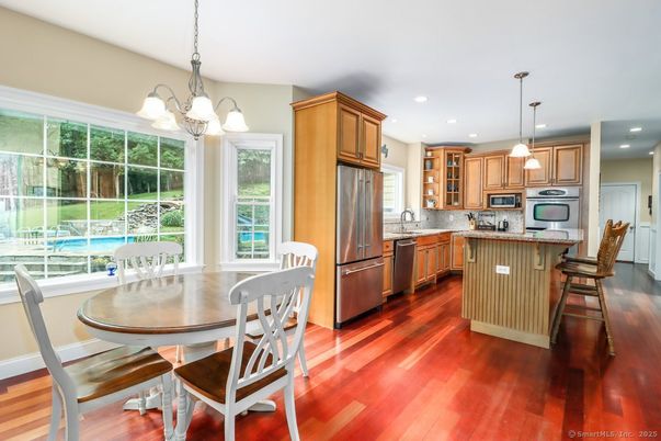 Dining room, Interior, Kitchen, Pendant Lights, Recessed Lighting, Stainless Steel Appliances, Wood Texture Flooring