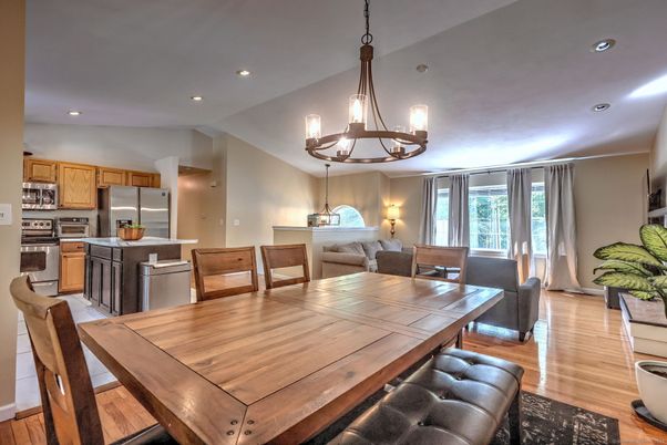 Chandelier, Dining room, Interior, Kitchen, Living room, Pendant Lights, Recessed Lighting, Stainless Steel Appliances, Wood Texture Flooring
