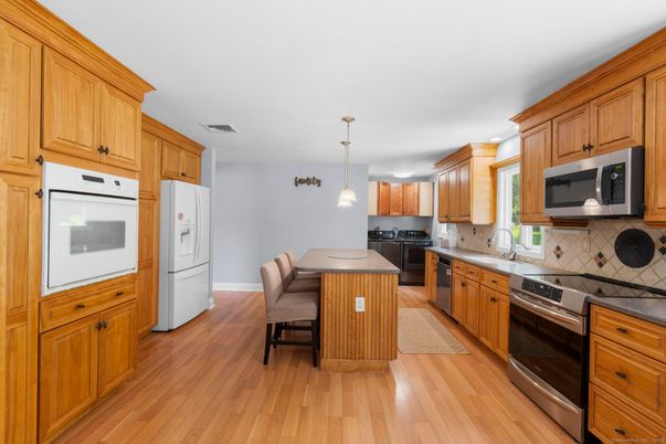 Dining room, Interior, Kitchen, Pendant Lights, Recessed Lighting, Stainless Steel Appliances, Wood Texture Flooring