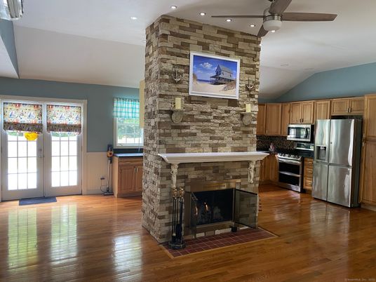 Fireplace, Interior, Kitchen, Recessed Lighting, Stainless Steel Appliances, Stone Walls, Wood Texture Flooring