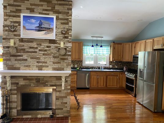 Fireplace, Interior, Kitchen, Pendant Lights, Recessed Lighting, Stainless Steel Appliances, Stone Walls, Wood Texture Flooring