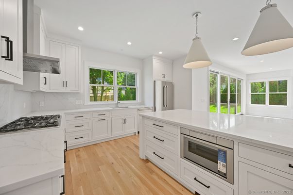 Interior, Kitchen, Marble Walls, Pendant Lights, Recessed Lighting, Stainless Steel Appliances, Wood Texture Flooring