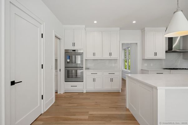 Interior, Kitchen, Marble Walls, Pendant Lights, Recessed Lighting, Stainless Steel Appliances, Wood Texture Flooring