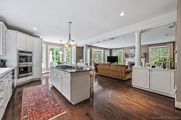 Fireplace, Interior, Kitchen, Living room, Pendant Lights, Recessed Lighting, Stainless Steel Appliances, Wood Texture Flooring