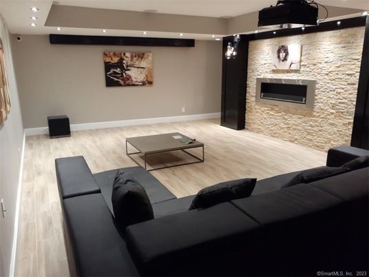 Fireplace, Interior, Living room, Recessed Lighting, Stone Walls, Wood Texture Flooring