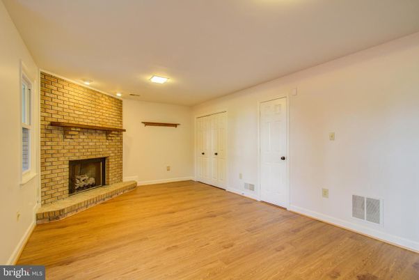 Empty room, Fireplace, Interior, Recessed Lighting, Stone Walls, Wood Texture Flooring