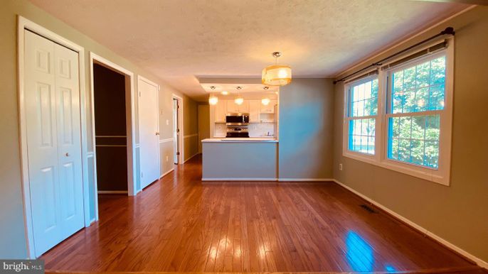 Empty room, Interior, Kitchen, Pendant Lights, Stainless Steel Appliances, Wood Texture Flooring
