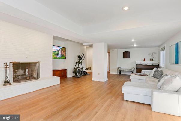 Fireplace, Fitness Equipment, Interior, Living room, Recessed Lighting, Wood Texture Flooring