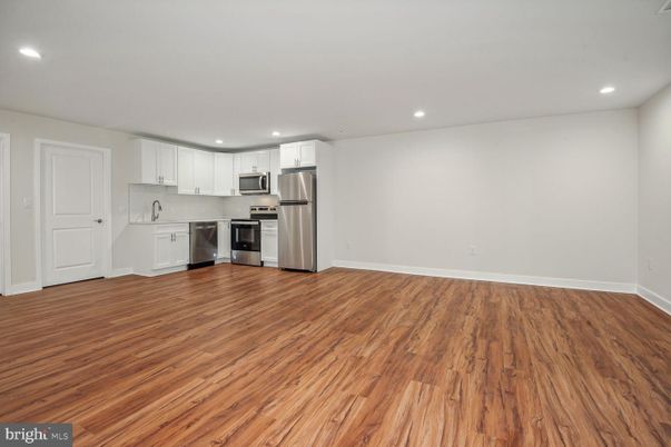 Empty room, Interior, Kitchen, Recessed Lighting, Stainless Steel Appliances, Wood Texture Flooring