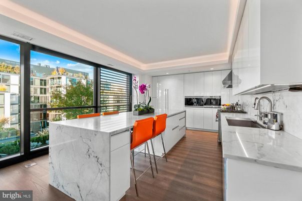 Interior, Kitchen, Marble Walls, Recessed Lighting, Stainless Steel Appliances, Wood Texture Flooring