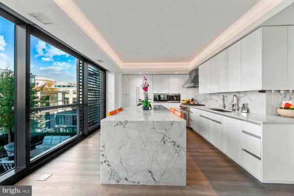Interior, Kitchen, Marble Walls, Recessed Lighting, Stainless Steel Appliances, Wood Texture Flooring