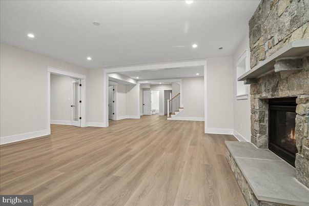 Empty room, Fireplace, Interior, Recessed Lighting, Stone Walls, Wood Texture Flooring