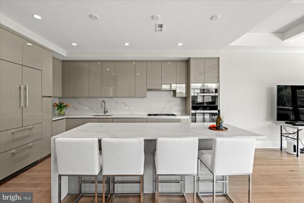 Interior, Kitchen, Marble Walls, Recessed Lighting, Stainless Steel Appliances, Wood Texture Flooring