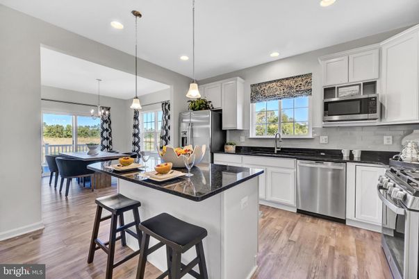 Chandelier, Dining room, Interior, Kitchen, Pendant Lights, Recessed Lighting, Stainless Steel Appliances, Wood Texture Flooring