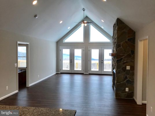 Empty room, Fireplace, Interior, Recessed Lighting, Stone Walls, Wood Texture Flooring