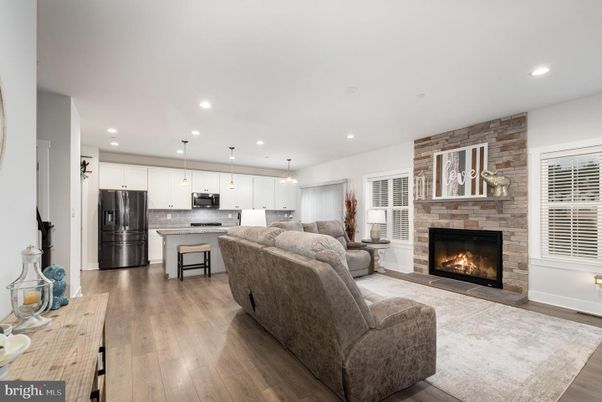 Fireplace, Interior, Kitchen, Living room, Pendant Lights, Recessed Lighting, Stainless Steel Appliances, Stone Walls, Wood Texture Flooring
