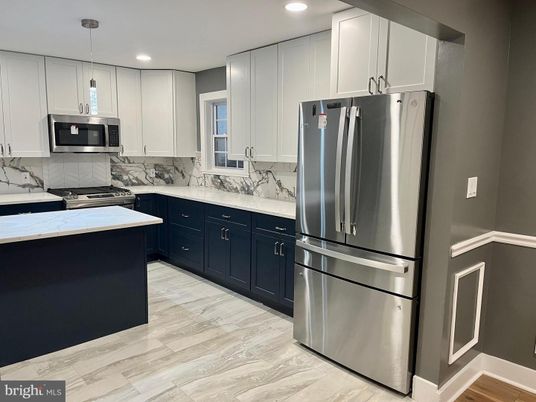 Interior, Kitchen, Marble Walls, Pendant Lights, Recessed Lighting, Stainless Steel Appliances, Wood Texture Flooring