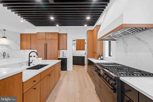 Interior, Kitchen, Marble Walls, Pendant Lights, Recessed Lighting, Stainless Steel Appliances, Wood Texture Flooring