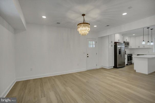 Chandelier, Empty room, Interior, Kitchen, Pendant Lights, Recessed Lighting, Stainless Steel Appliances, Wood Texture Flooring