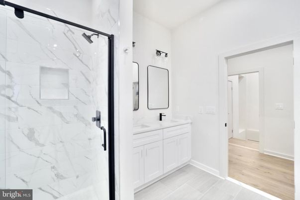 Bathroom, Dual Sink Vanities, Glass Shower, Interior, Marble Walls, Wood Texture Flooring