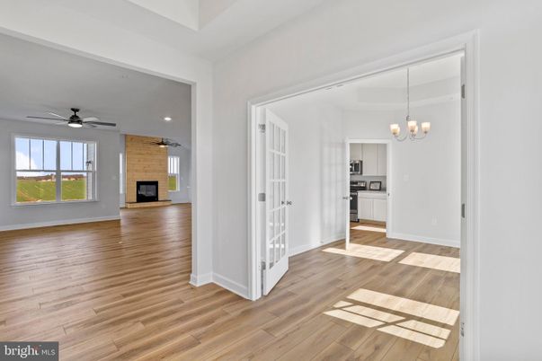 Chandelier, Empty room, Fireplace, Interior, Kitchen, Recessed Lighting, Wood Texture Flooring