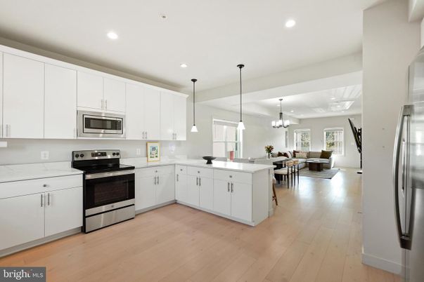 Chandelier, Dining room, Interior, Kitchen, Living room, Pendant Lights, Recessed Lighting, Stainless Steel Appliances, Wood Texture Flooring