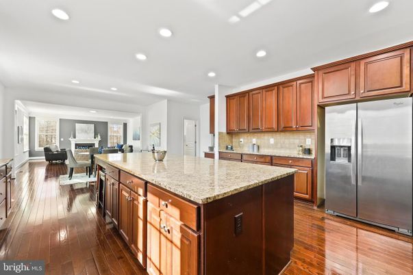 Dining room, Fireplace, Interior, Kitchen, Living room, Recessed Lighting, Stainless Steel Appliances, Wood Texture Flooring