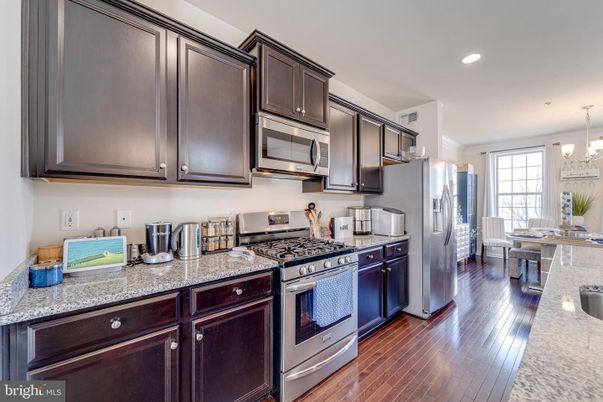 Chandelier, Dining room, Interior, Kitchen, Recessed Lighting, Stainless Steel Appliances, Wood Texture Flooring