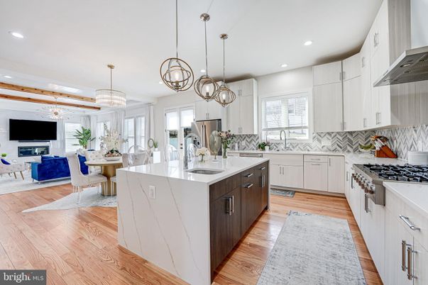 Chandelier, Dining room, Fireplace, Interior, Kitchen, Living room, Pendant Lights, Recessed Lighting, Stainless Steel Appliances, Wood Texture Flooring