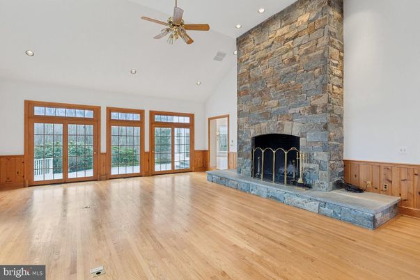 Empty room, Fireplace, Interior, Recessed Lighting, Stone Walls, Wood Texture Flooring