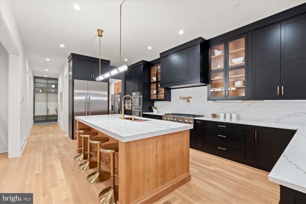 Interior, Kitchen, Marble Walls, Pendant Lights, Recessed Lighting, Stainless Steel Appliances, Wood Texture Flooring
