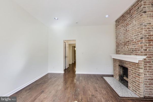 Empty room, Fireplace, Interior, Recessed Lighting, Stone Walls, Wood Texture Flooring