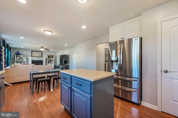Dining room, Fireplace, Interior, Kitchen, Living room, Recessed Lighting, Stainless Steel Appliances, Wood Texture Flooring