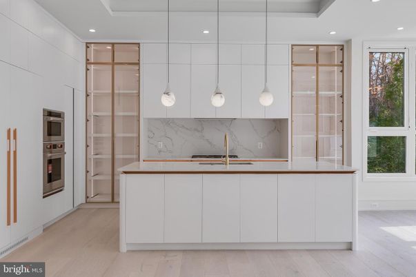 Interior, Kitchen, Marble Walls, Pendant Lights, Recessed Lighting, Stainless Steel Appliances, Wood Texture Flooring