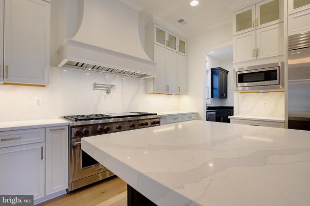 Interior, Kitchen, Marble Walls, Recessed Lighting, Stainless Steel Appliances, Wood Texture Flooring