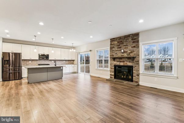 Fireplace, Interior, Kitchen, Pendant Lights, Recessed Lighting, Stainless Steel Appliances, Stone Walls, Wood Texture Flooring