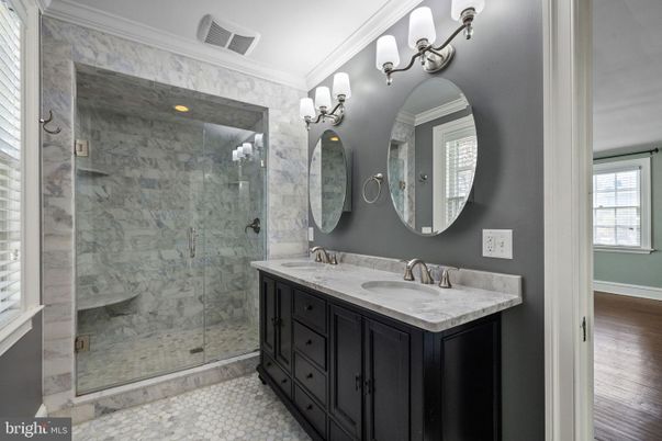 Bathroom, Dual Sink Vanities, Glass Shower, Interior, Marble Walls, Wood Texture Flooring