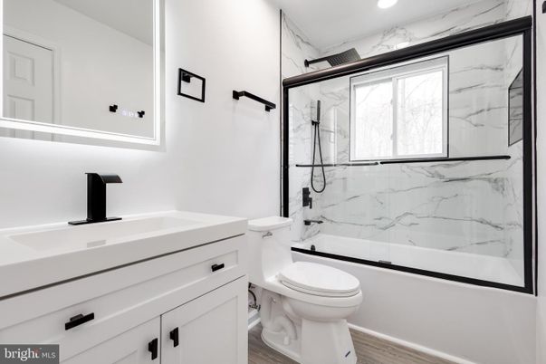 Bathroom, Glass Shower, Interior, Marble Walls, Recessed Lighting, Wood Texture Flooring