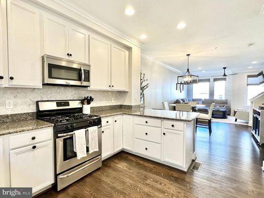 Chandelier, Dining room, Interior, Kitchen, Living room, Pendant Lights, Recessed Lighting, Stainless Steel Appliances, Wood Texture Flooring