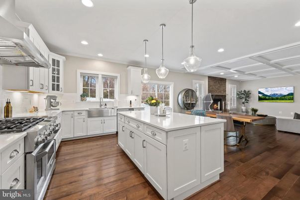 Dining room, Fireplace, Interior, Kitchen, Pendant Lights, Recessed Lighting, Stainless Steel Appliances, Stone Walls, Wood Texture Flooring