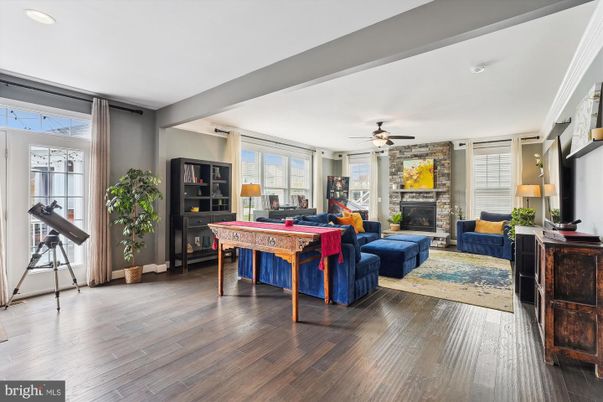 Fireplace, Game Room, Interior, Living room, Recessed Lighting, Stone Walls, Wood Texture Flooring