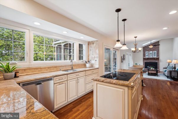 Fireplace, Interior, Kitchen, Living room, Pendant Lights, Recessed Lighting, Stainless Steel Appliances, Stone Walls, Wood Texture Flooring