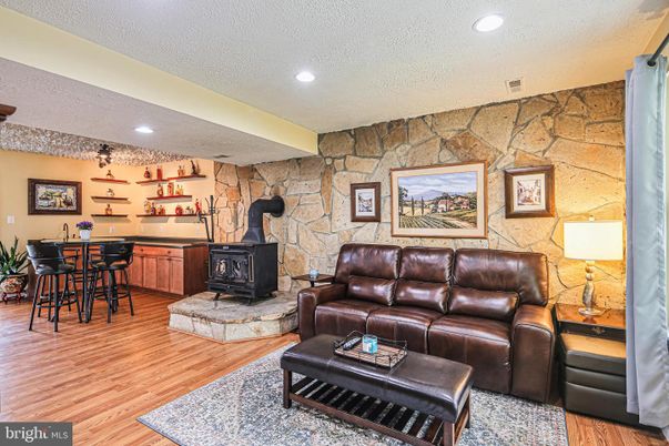 Fireplace, Interior, Living room, Recessed Lighting, Stone Walls, Wood Texture Flooring