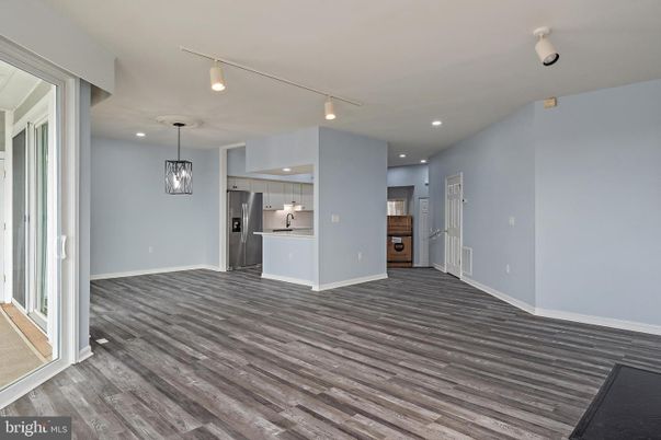 Empty room, Interior, Kitchen, Pendant Lights, Recessed Lighting, Stainless Steel Appliances, Wood Texture Flooring