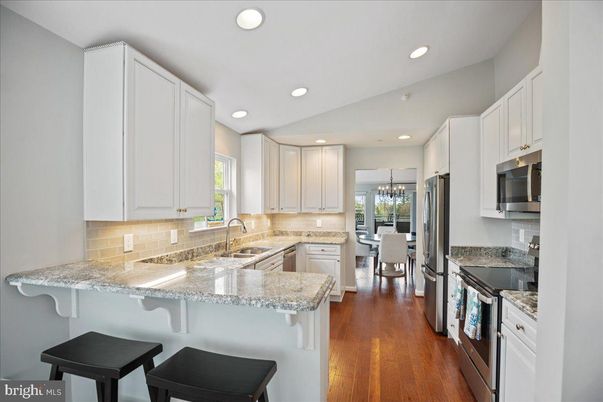 Chandelier, Dining room, Interior, Kitchen, Recessed Lighting, Stainless Steel Appliances, Wood Texture Flooring