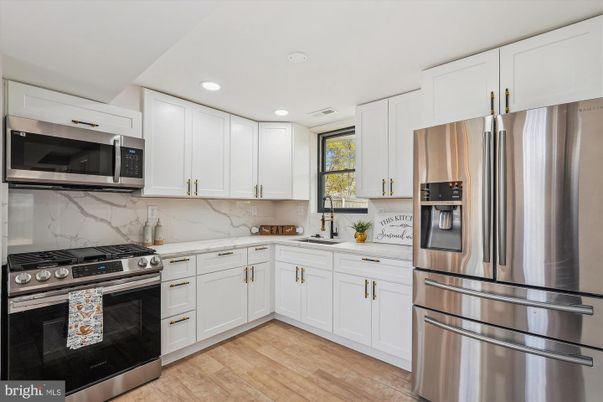 Interior, Kitchen, Marble Walls, Recessed Lighting, Stainless Steel Appliances, Wood Texture Flooring