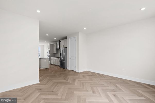 Empty room, Interior, Kitchen, Recessed Lighting, Stainless Steel Appliances, Wood Texture Flooring