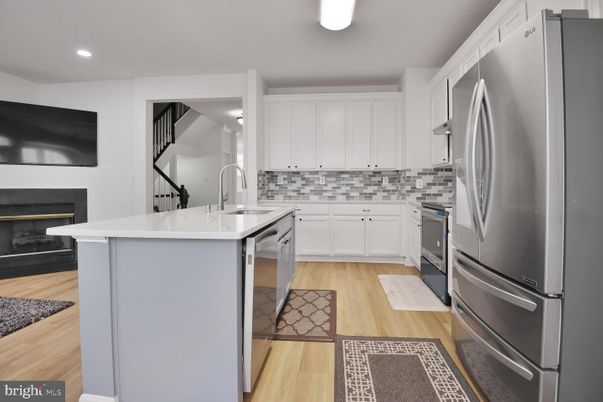 Fireplace, Interior, Kitchen, Recessed Lighting, Stainless Steel Appliances, Wood Texture Flooring