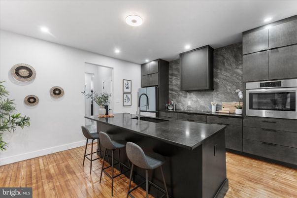 Interior, Kitchen, Marble Walls, Recessed Lighting, Stainless Steel Appliances, Wood Texture Flooring