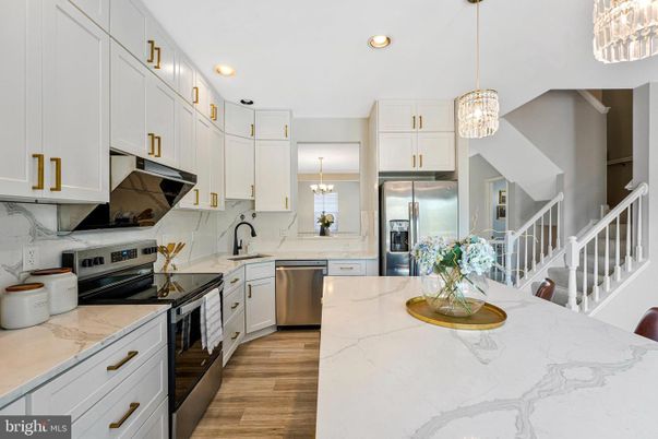 Interior, Kitchen, Marble Walls, Pendant Lights, Recessed Lighting, Stainless Steel Appliances, Wood Texture Flooring
